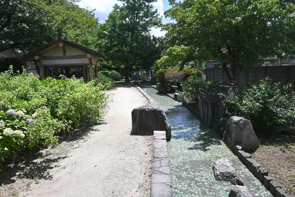 夏の風景。あずまやのそばを水がさらさらと流れている
